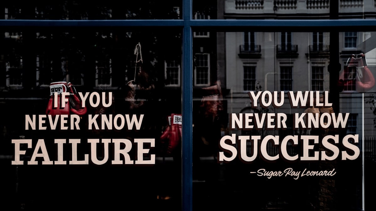 Motivational sign in the window of a boxing gym.